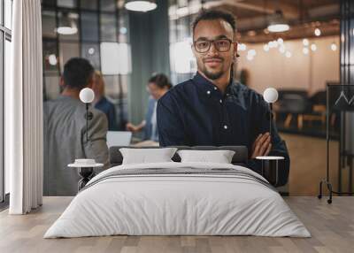 Confident young businessman working in a modern office Wall mural