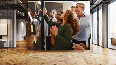 Diverse businesspeople brainstorming together with sticky notes Wall mural