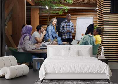 Diverse businesspeople discussing work in a meeting Wall mural