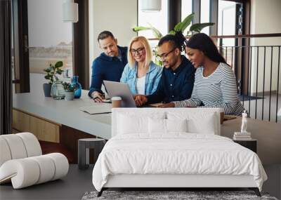 Diverse businesspeople working on a laptop in an office Wall mural