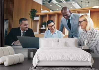 Diverse group of businesspeople laughing together during an offi Wall mural