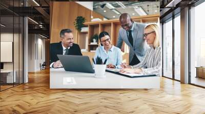 Diverse group of businesspeople laughing together during an offi Wall mural