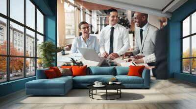 Diverse group of businesspeople laughing together in an office Wall mural