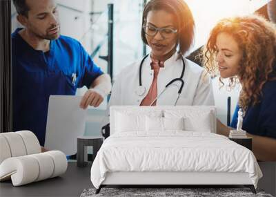 diverse group of doctors talking together in a hospital corridor Wall mural