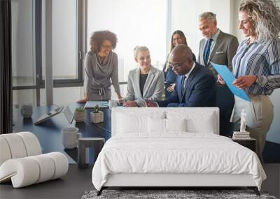 Diverse group of executives working together around a boardroom table Wall mural