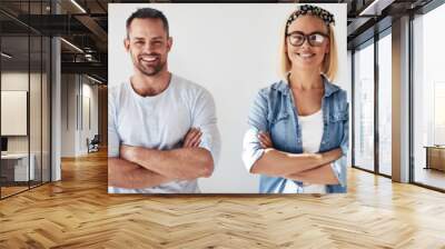 Diverse group of smiling colleagues standing with their arms cro Wall mural