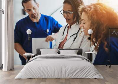 Diverse medical professionals talking together in a hospital cor Wall mural