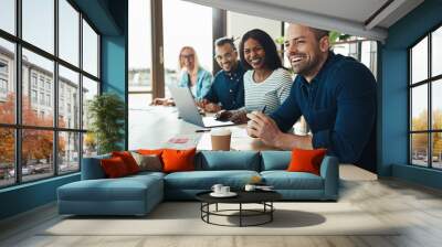 Diverse office colleagues laughing together during a meeting Wall mural