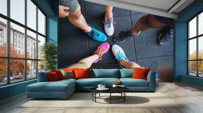 Diverse people wearing running shoes standing in a gym Wall mural