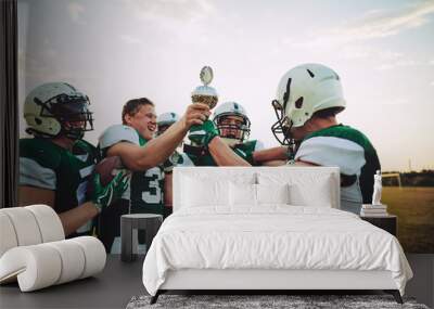 Ecstatic football team celebrating together with a championship Wall mural