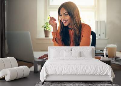 Female entrepreneur working on a laptop in her home office Wall mural