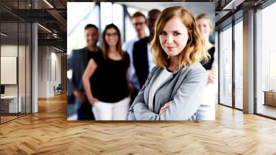 female executive gazing at camera with arms crossed Wall mural