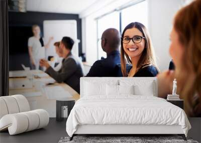 Female executive smiling at camera during work presentation Wall mural