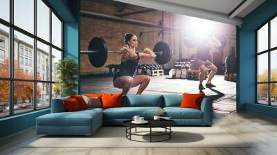 Fit people training lift barbells in gym Wall mural