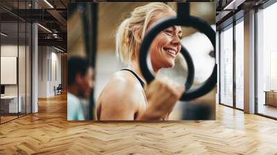 Fit woman preparing to workout with rings at the gym Wall mural