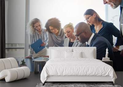 Focused group of office colleagues reading paperwork in a boardroom Wall mural