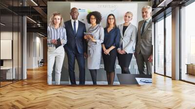 Focused team of diverse business strategists standing in an office Wall mural