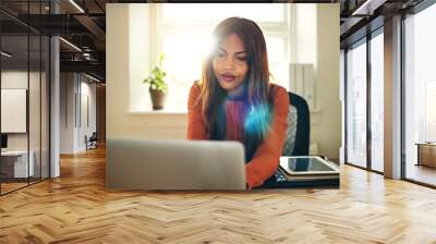 Focused young woman working online in her home office Wall mural