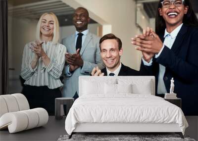 Group of businesspeople smiling and clapping after an office pre Wall mural