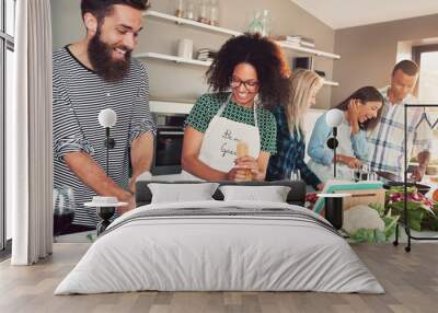 Group of friends cheerfully cooking Wall mural