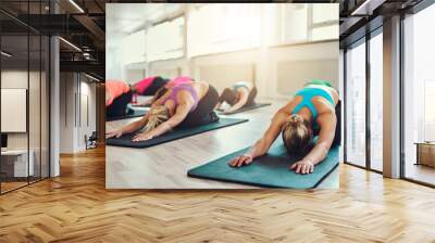 group of young women doing youga exercise Wall mural