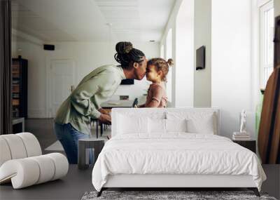 Loving mom and her little girl having a snack at home Wall mural