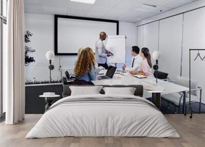 Manager giving a presentation to staff in an office boardroom Wall mural