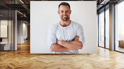 Mature entrepreneur standing with arms crossed on a white backgr Wall mural