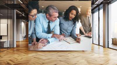 Multiracial workers discussing papers sitting in office Wall mural