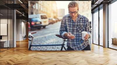 outdoor portrait of modern young man with mobile phone Wall mural