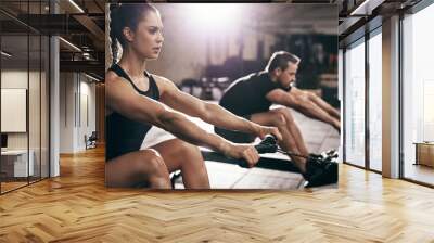 People in gym execising on weigh-lifting machine Wall mural