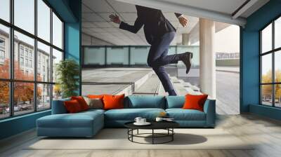 Running up fast man wearing suit Wall mural