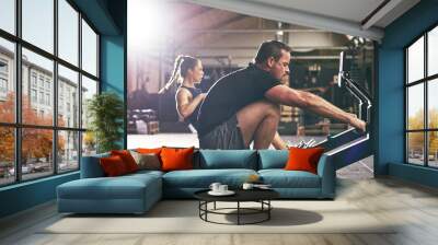 Side view of two sportsmen on simulators Wall mural