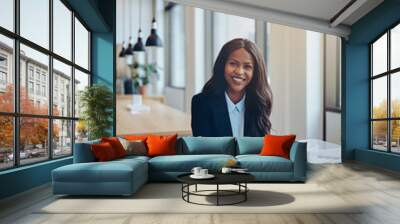 Smiling African American businesswoman working in an office loun Wall mural