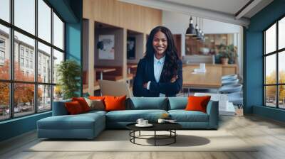 Smiling African American woman standing in an office lounge Wall mural