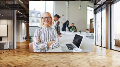 Smiling businesswoman working at boardroom table in an office Wall mural