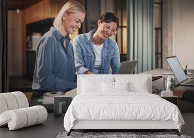 Smiling businesswomen working together on a laptop in an office Wall mural