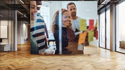 Smiling designers having a brainstorming session in an office Wall mural