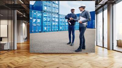 Smiling engineers shaking hands together in a shipping yard Wall mural