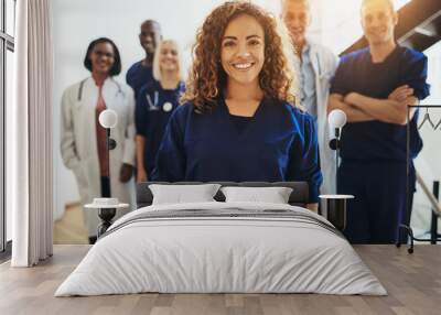 Smiling female doctor standing with medical colleagues in a hosp Wall mural