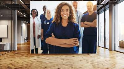 smiling female doctor standing with medical staff in a hospital Wall mural