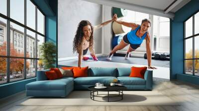 Smiling friends high fiving each other while exercising together Wall mural