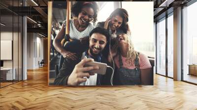 Smiling friends listening to music together on a bus Wall mural