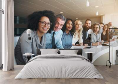 Smiling group of diverse colleagues working together in an office Wall mural