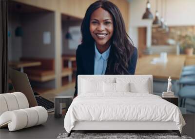 Smiling young African American businesswoman working in an offic Wall mural