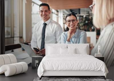 Smiling young businesswoman working with colleagues in an office Wall mural