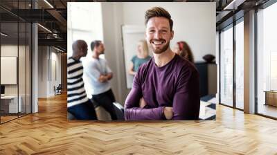 Smiling young designer standing in an office after a presentatio Wall mural