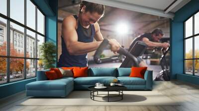 Sportsmen working out hard on cycling machines Wall mural