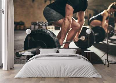 Strong man doing deadlift training in gym Wall mural