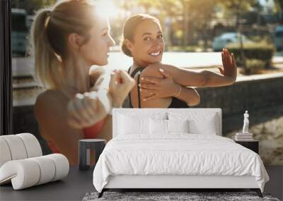 Two fit women smiling and stretching before an outdoor run Wall mural